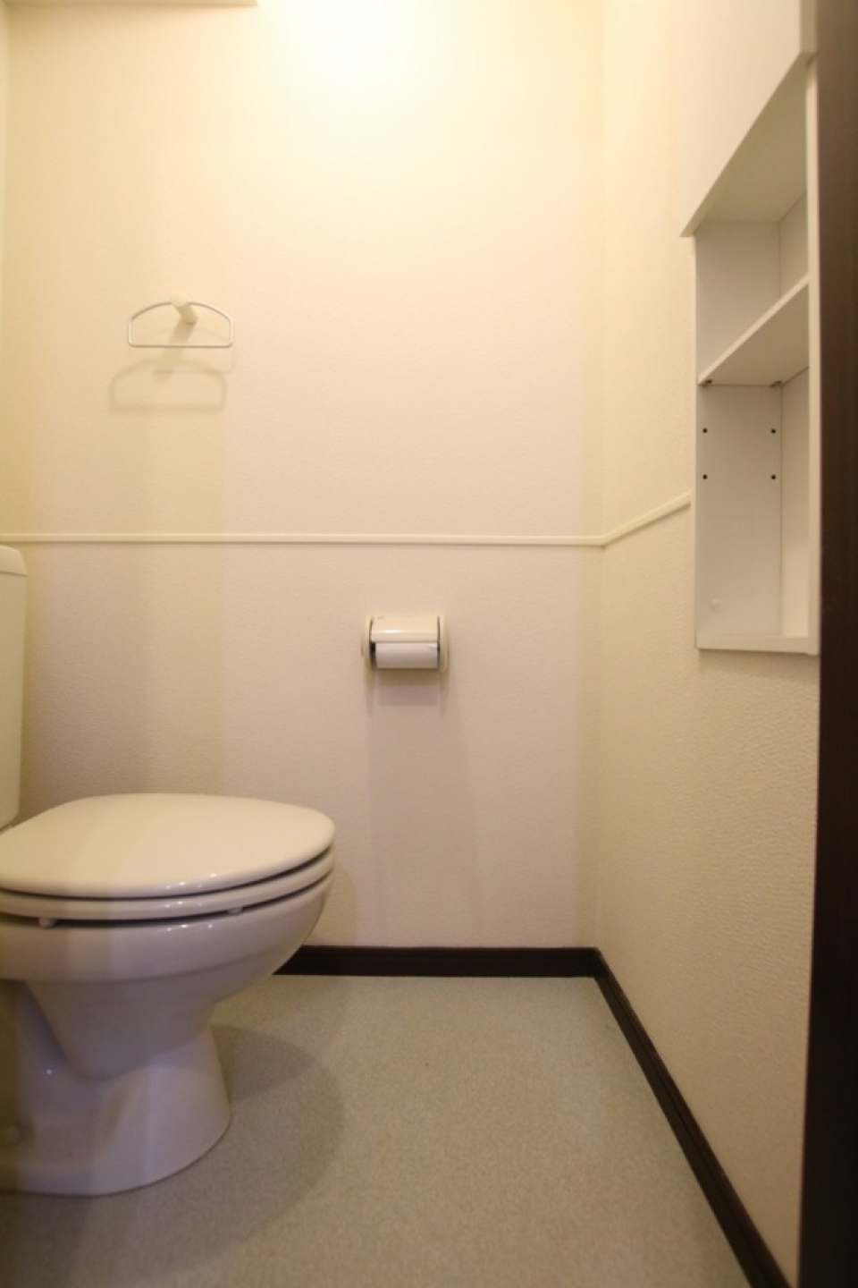 トイレにはペーパーや掃除道具が置き易い棚付き。シャワートイレではない。
