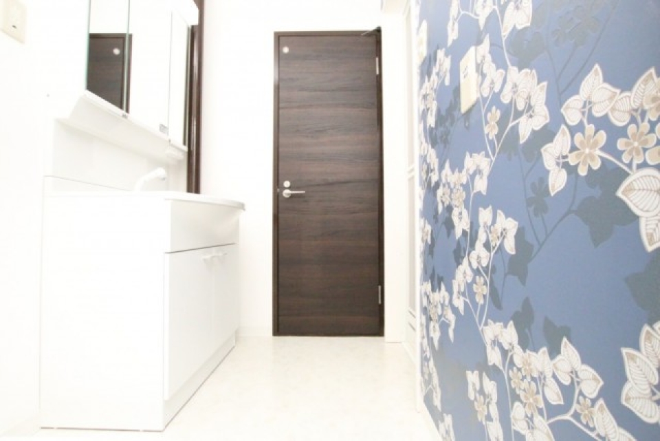 アクセントウォールがポイントの脱衣所、奥の扉がトイレです。