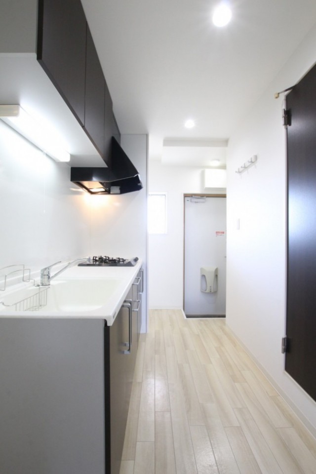 ナチュラルなフロアで明るいキッチン空間。