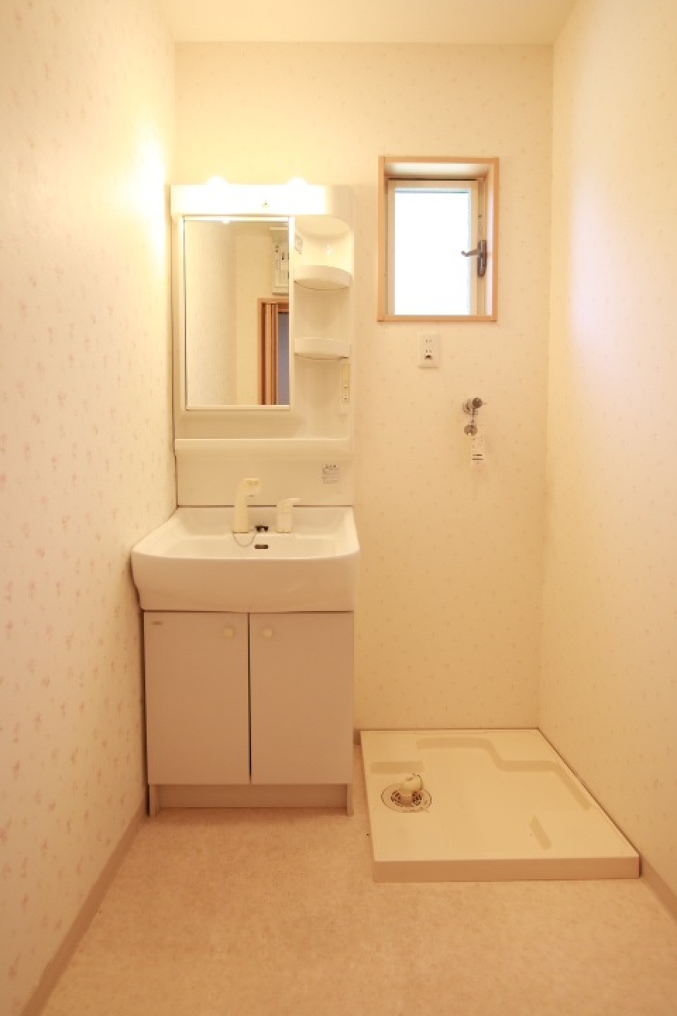 洗面室には小花のちらつく壁紙。