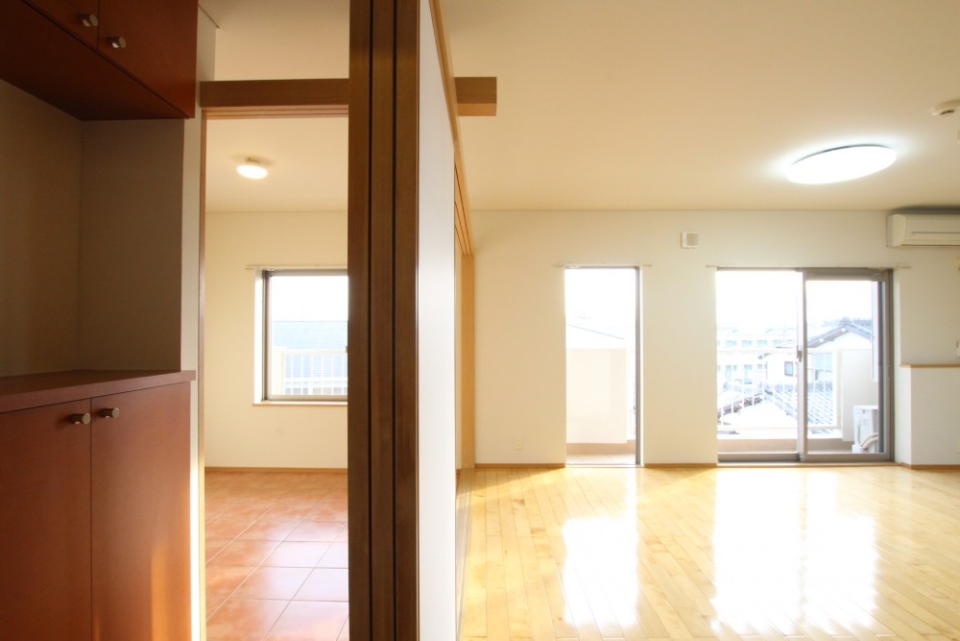 フローリング空間のLDKと土間空間の寝室。