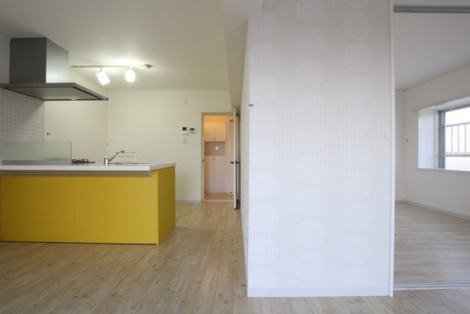 白い空間に映える山吹色キッチン