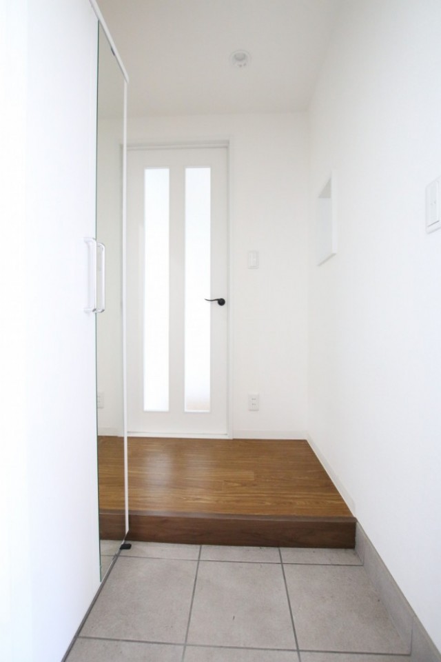 玄関には大きなシューズボックスと姿見鏡