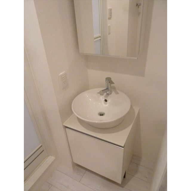 洗面台です。丸いデザインでお洒落ですね。