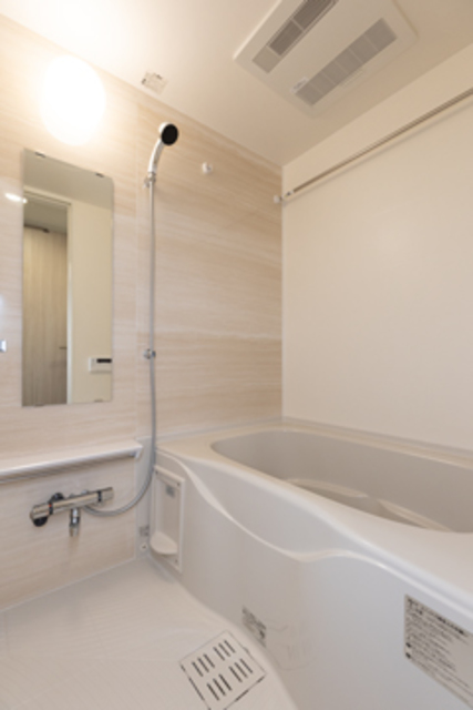 さりげなく木目調のパネルが使われた浴室。※写真は同タイプ住戸です。