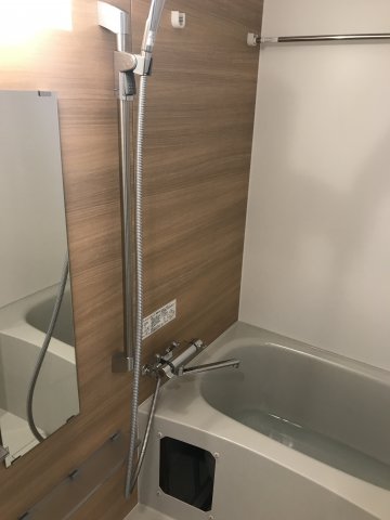 アクセントパネルがウッドテイストで癒し空間を演出。浴室乾燥機付きのバスルームです。