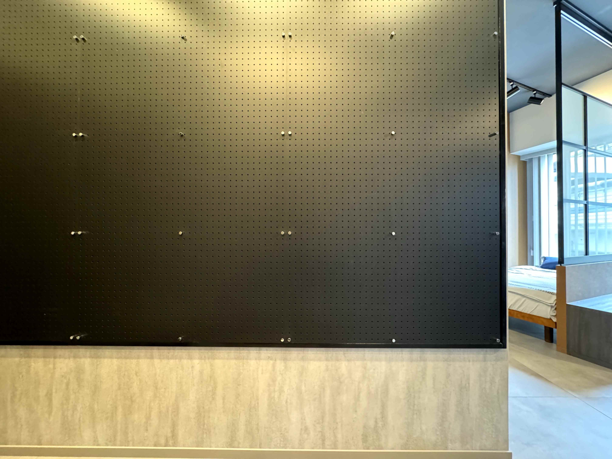 玄関正面の壁はブラックの有孔ボードになっている。