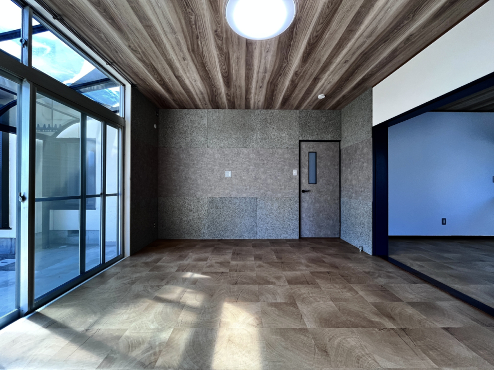 木目調の天井とフロアにとモルタル風のクロスが融合